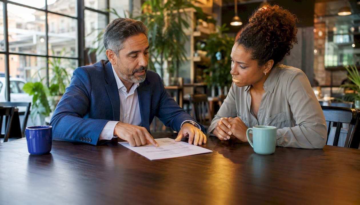 Real estate agent and seller discussing negotiation