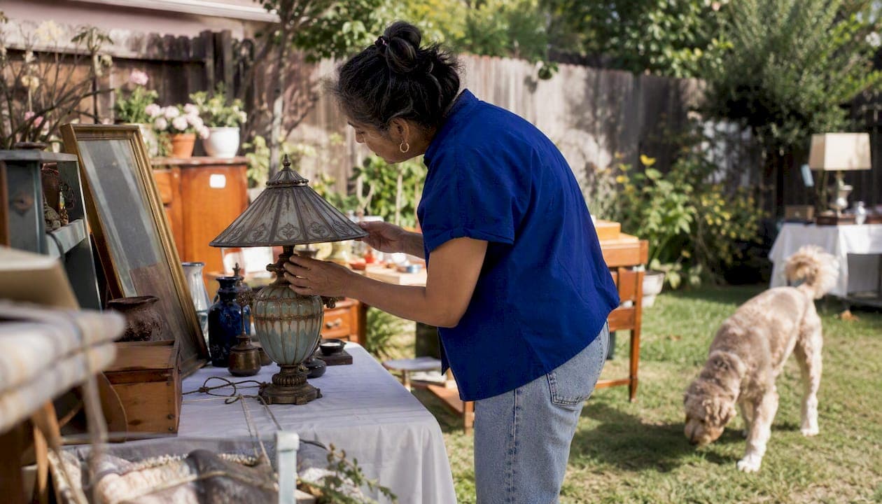Woman assessing items at an estate sale